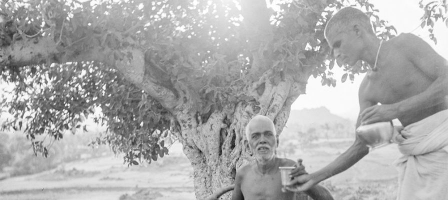 Bhagavan being given water by Madhava Swami on the lower slopes of Arunachala