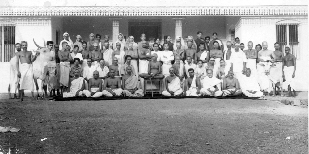 The opening of the cowshed, Lakshmi left and Bhagavan seated in the centre