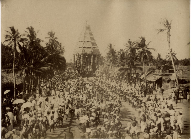 This is the oldest known photo of Tiruvannamalai. It is the start of the Big Car procession in 1880. It is taken from the end of Car Street on the junction of Tiruvoodal Street. The two lines of devotees are about to begin pulling the cahariot clockwise around the Arunachalewara Temple.